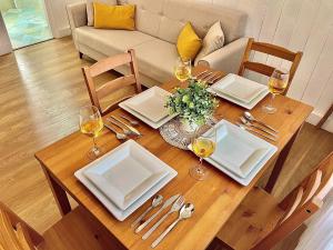 a wooden table with plates and glasses of wine at Las Brisas 1 by SunHousescanarias in Las Palmas de Gran Canaria