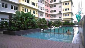 a swimming pool in the middle of a building at Ehime Suites One Regis Bacolod in Bacolod
