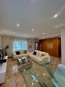 a living room with two couches and a table at Nell&And&Jess HOME in Espinho