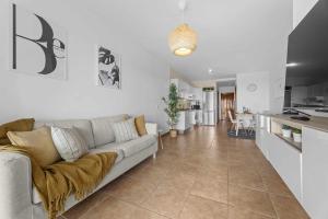 a living room with a couch and a kitchen at HOLYHOME SunSplash in Costa Teguise