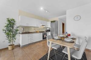 a kitchen and dining room with a table and chairs at HOLYHOME SunSplash in Costa Teguise