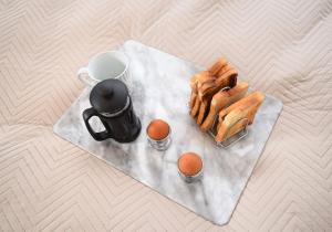 a tray with a cup of coffee and eggs on a table at Whifflet Apartment by Klass Living Coatbridge in Coatbridge