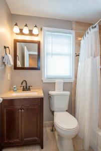 a bathroom with a toilet and a sink and a window at Villas at Hawks Cay Resort in Duck Key