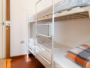 Postel nebo postele na pokoji v ubytování Bilocale Mughetto