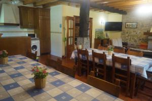 a large dining room with a table and chairs at Goikoetxe Baserria in Zeanuri