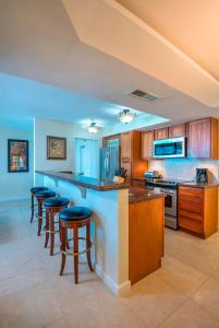 a kitchen with a island with bar stools at Villas at Hawks Cay Resort in Duck Key
