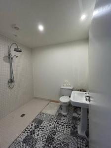 a bathroom with a shower and a toilet and a sink at Spacious and Cozy Home with Ocean Views in Lifford