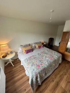 a bedroom with a bed and a desk and a table at Spacious and Cozy Home with Ocean Views in Lifford