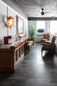 a living room with a table and chairs and a couch at Hunter Arms Hotel in Saint Cloud