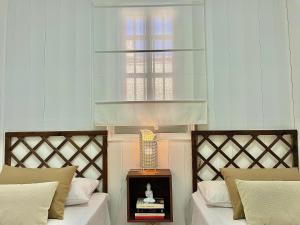 a bedroom with two beds and a window at Las Brisas 1 by SunHousescanarias in Las Palmas de Gran Canaria