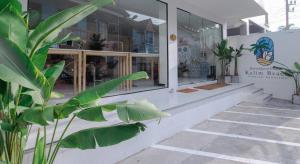 a store front with a plant in front of it at RoomQuest Kalim Beach in Patong Beach