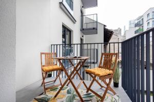 two chairs and a table on a balcony at Spacious and modern Apartment Lwowska, close to Kazimierz in Kraków