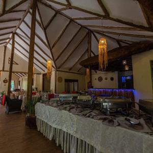 a large room with a long table in a building at Gorilla Safari Lodge in Rubuguli