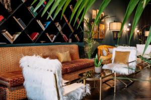 a living room with couches and a table and plants at Skylark, Aluma Hotels & Resorts in Athens