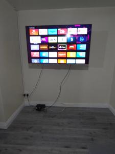 a flat screen tv hanging on a wall at Stylish property near town centre in Tyldesley