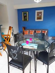 a dining room with a glass table and chairs at Appartement d'une chambre avec jardin clos et wifi a La Trinite in La Trinité