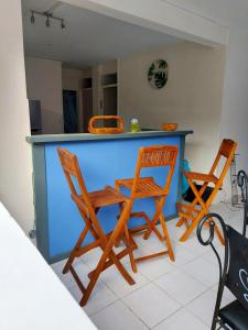 a kitchen with two chairs and a blue counter at Appartement d'une chambre avec jardin clos et wifi a La Trinite in La Trinité