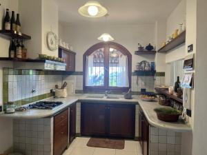 a kitchen with a sink and a window at Villa Le Anfore in Imperia
