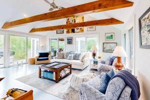 a living room with couches and a table at Water Overlook in Oak Bluffs