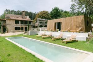 a swimming pool in the yard of a house at Numa Experimental in Pontevedra