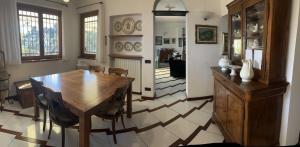 a dining room with a wooden table and chairs at Villa Le Anfore in Imperia +57 photos