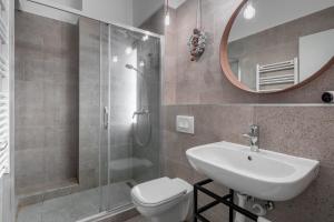 a bathroom with a toilet and a sink and a mirror at Extra Central Modern Studio in Budapest