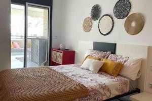 a bedroom with a bed and mirrors on the wall at Casa Calinka in Sant Jordi +21 photos