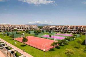 an apartment complex with a tennis court and apartments at Casa Calinka in Sant Jordi