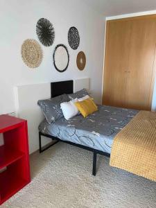 a bedroom with a bed and a wall with mirrors at Casa Calinka in Sant Jordi