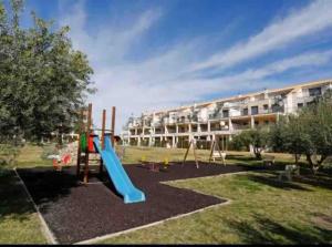 a playground with a slide in front of a building at Casa Calinka in Sant Jordi
