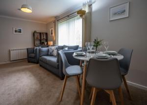 a living room with a table and a couch at Number 4 in Fort William