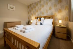 a bedroom with a bed with towels on it at Number 4 in Fort William