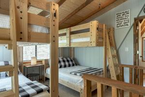 a bedroom with two bunk beds in a cabin at 1236 Hideaway Lake Chalet by Sarah Bernard Chalets with Private Dock and Hot Tub in Innsbrook