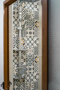 a shower in a bathroom with a tiled wall at DAR SABA in Rabat