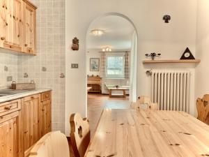 a kitchen with a wooden table in a room at Cesa Cascata in Canazei