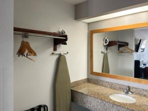 a bathroom with a sink and a mirror at Motel 6 Laurel, MS in Laurel