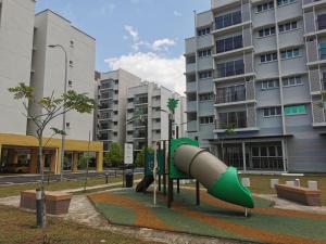 a playground with a slide in front of a building at Apartment Alor Gajah in Kampong Alor Gajah