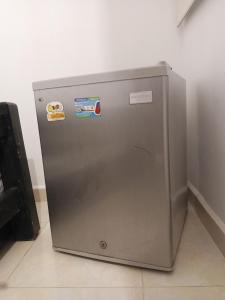 a metal refrigerator with stickers on the side of it at Habitaciones en el Rodadero Sur in Gaira