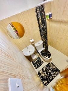 a bathroom with a toilet and a sink at ANDRO'S LOFT near General Santos City Airport in General Santos