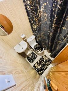 a bathroom with a toilet and a sink at ANDRO'S LOFT near General Santos City Airport in General Santos