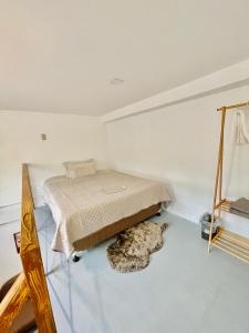 a bedroom with a bed and a cat laying on the floor at ANDRO'S LOFT near General Santos City Airport in General Santos