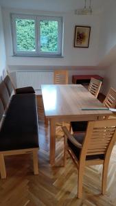 a dining room with a wooden table and chairs at Apartment in Ossiach in Altossiach