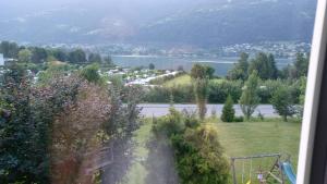 a view of a garden with a lake in the background at Apartment in Ossiach in Altossiach