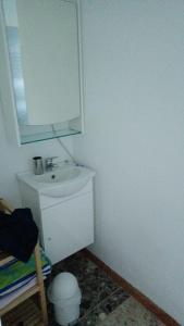 a white bathroom with a sink and a mirror at Apartment in Ossiach in Altossiach