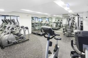 a gym with a lot of tread machines in it at Riverview 2BR delicate Apt, 1min to train station in Brisbane