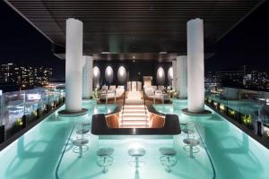 a pool on the top of a building at night at Story Bridge and City View Skyhigh Luxe 2 bed Unit in Brisbane