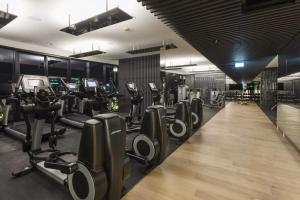 a gym with a row of treadmills and machines at Story Bridge and City View Skyhigh Luxe 2 bed Unit in Brisbane