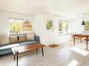 a living room with a couch and a table at Holiday home Læsø in Læsø