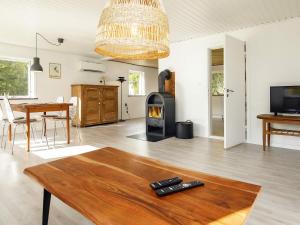 a living room with a wood burning stove in it at Holiday home Læsø in Læsø