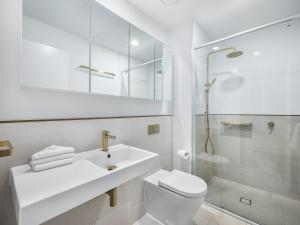 a bathroom with a sink and a toilet and a shower at Riverside 2BR delicate apt in Gold Coast